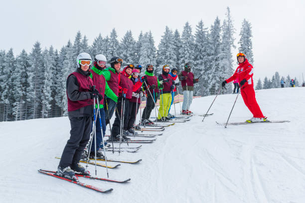 Students and teacher of ski school. 2016-12-19 Bukovel, Ukraine. Students and teacher of ski school. Winter outdoor activity in Ukraine ski instructor stock pictures, royalty-free photos & images