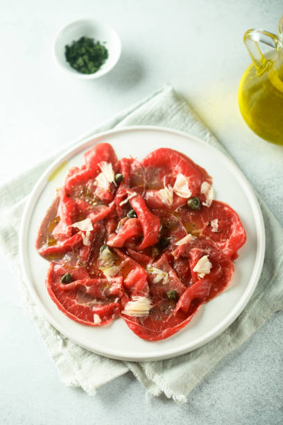 Beef carpaccio Traditional homemade beef carpaccio carpaccio parmesan cheese beef raw stock pictures, royalty-free photos & images