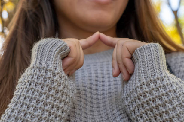 istock Woman in sweater touching fingers. 1288590612