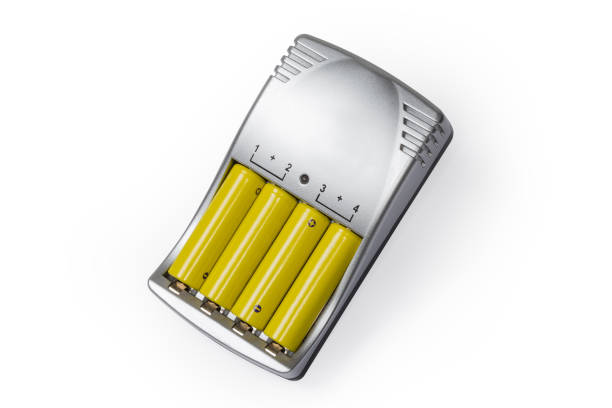 Rechargeable batteries AA size inserted in a smart battery charger on a white background