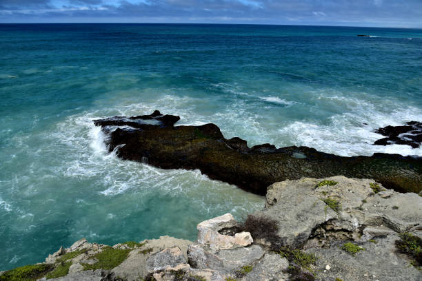 istock A black rock in a blue sea 1288595257