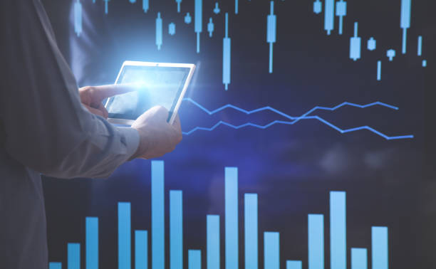 istock Businessman using tablet and working in financial graphs in screen. 1288596744