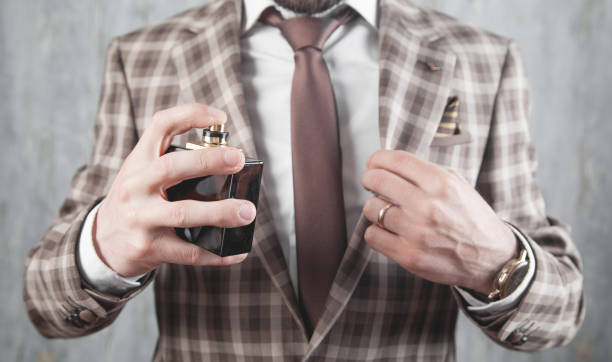 istock Caucasian elegant man spraying perfume. 1288596757