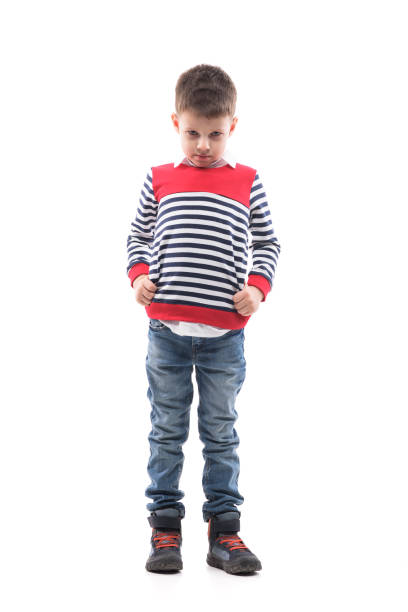 istock Emotional disappointed little boy with bowed head looking at camera unhappy. 1288596804