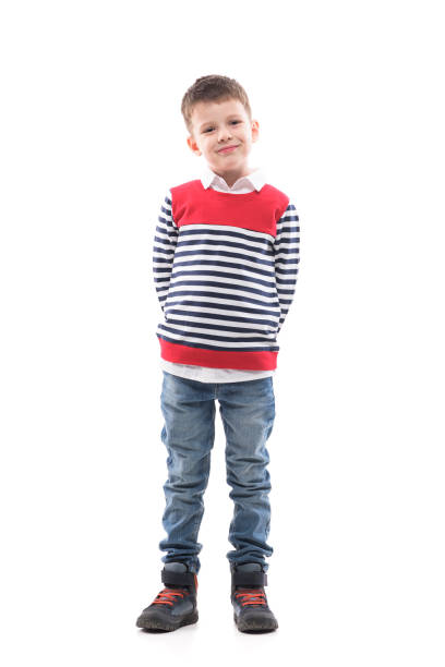 istock Cute stylish charming cool little boy in sweater posing with hands behind back 1288596842