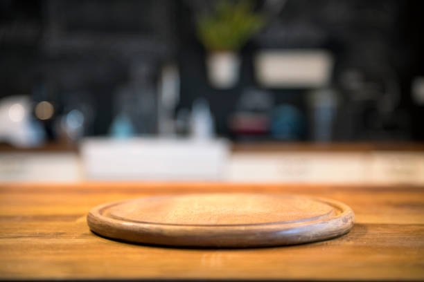 Empty wooden tabletop and defocused modern kitchen background for display or montage your products.