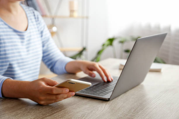 istock Unrecognizable female at home with laptop. 1288597819