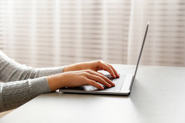 istock Unrecognizable female at home with laptop. 1288598092