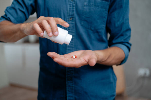istock young man with pills in his hands 1288600956