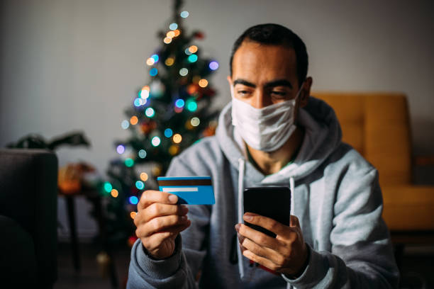 istock Man Using Phone For Christmas Shopping From Home 1288601056