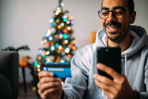 istock Man Using Phone For Christmas Shopping From Home 1288601879