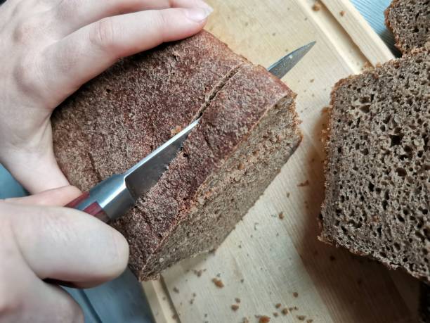istock women's hands cut into rye homemade bread made on sourdough 1288602241