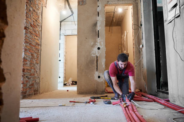 istock Male plumber installing heating system in apartment. 1288603229