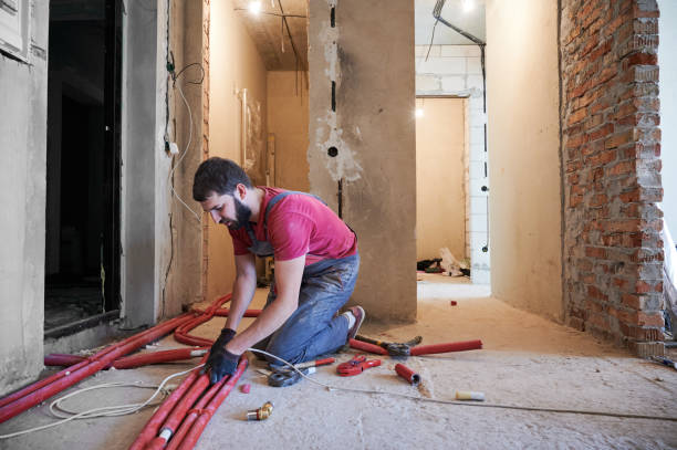 istock Young bearded plumber installing underfloor heating system in new apartment 1288603230