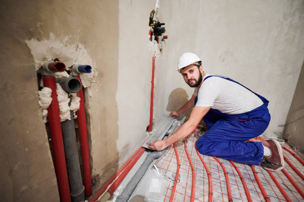 istock Male worker installing underfloor heating system in apartment. 1288603332
