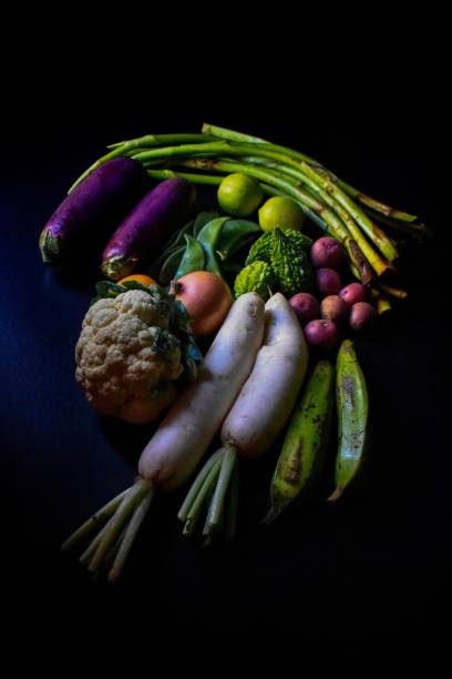 Vegetables Vegetables on a black background. taro leaf stock pictures, royalty-free photos & images