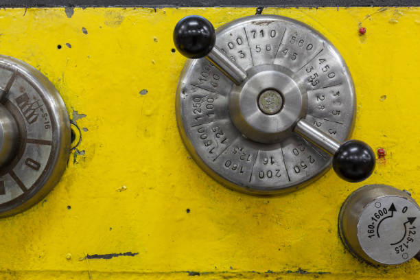 istock Old yellow lathe machine with a lot of handles. 1288605670