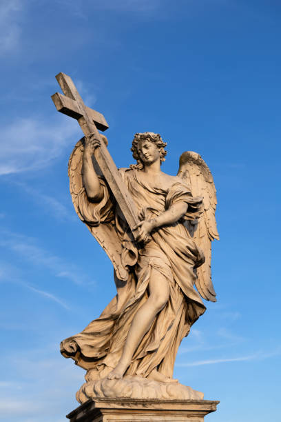 istock Angel Carrying the Cross Statue 1288606315