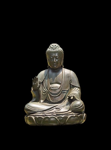 A Buddha statue in a park in Mumbai isolated on a black background