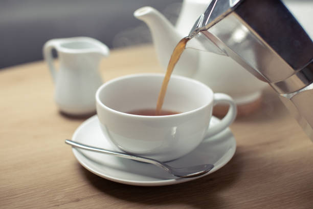 istock Pouring hot coffee in the white cup 1288610119