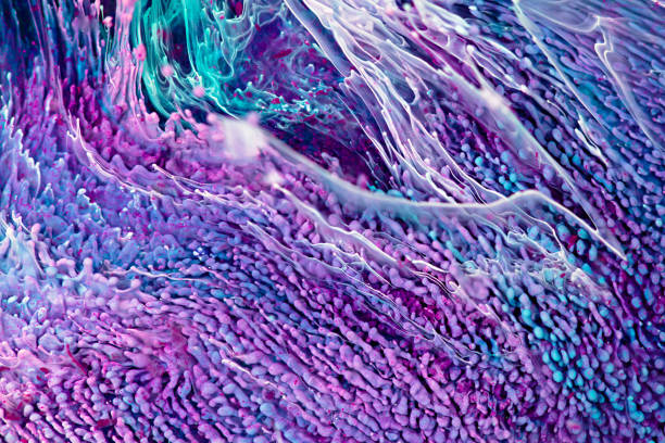 istock Epoxy resin texture with purple, aquamarine and white colors. Liquid backdrop with splashes and swirls. Modern abstract artwork with alcohol inks. Vibrant colors mixes on macrophotography poster. 1288610926
