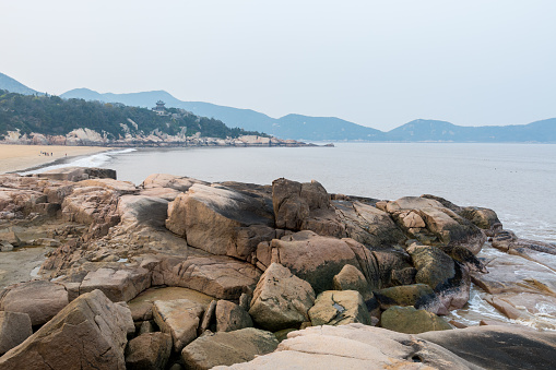 Rocky coastline and rocks and beach in the Putuoshan, Zhoushan Islands,  a renowned site in Chinese bodhimanda of the bodhisattva Avalokitesvara (Guanyin)