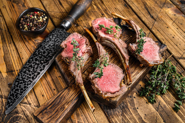 istock Grilled lamb rib chop steaks. wooden background. Top view 1288613084