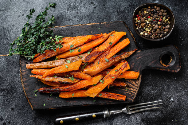 istock Roasted Sweet potatoes stripes. Black background. Top view 1288613923