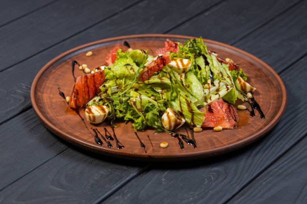 istock Fresh healthy salad on black wooden table 1288616555