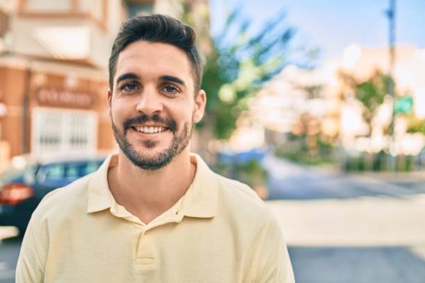 istock Young hispanic man smiling happy walking at the city. 1288618382