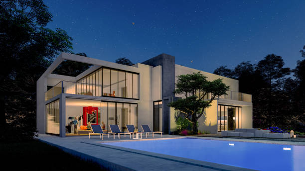 istock Big contemporary villa with pool illuminated in the evening 1288619669