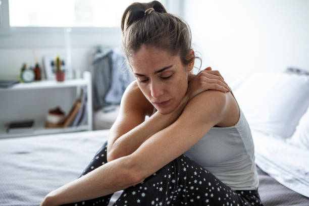istock Thoughtful woman sitting in bedroom 1288620960