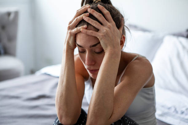 istock Sad woman sitting in bedroom 1288620983