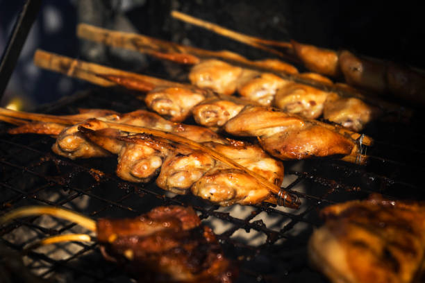 istock grilled chicken wings roasted chicken legs with herbs on background, horizontal top view from above. 1288622587