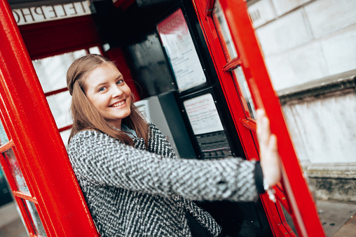 happiness woman in the telephone booth in london