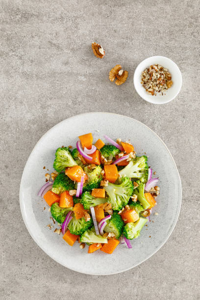 istock Vegan broccoli salad with baked pumpkin, red onion and walnuts 1288623604