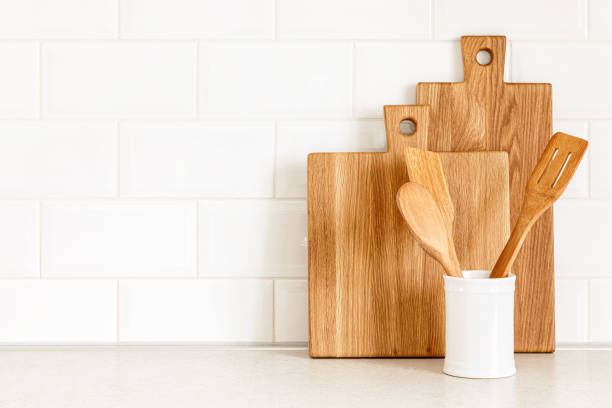 istock Kitchen utensils on countertop, culinary background, wooden and white ceramic kitchenware, home cooking concept 1288624015