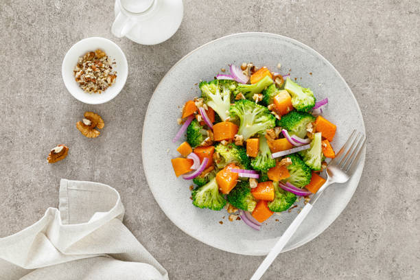 istock Vegan broccoli salad with baked pumpkin, red onion and walnuts 1288624018