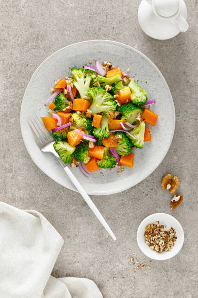 istock Vegan broccoli salad with baked pumpkin, red onion and walnuts 1288624964