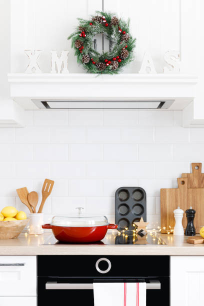 istock Christmas home kitchen interior with wooden worktop and kitchenware, holiday cooking background 1288625112