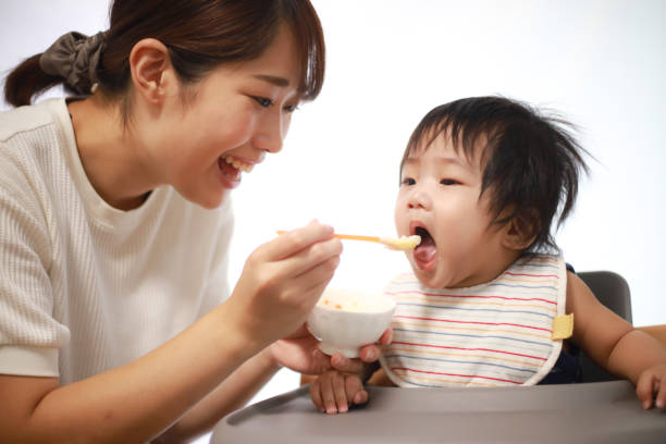 istock Mother feeding baby food 1288625428