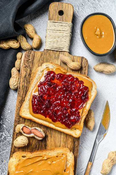 istock Peanut butter sandwich  toast with berry jam.  White background. Top view 1288625513