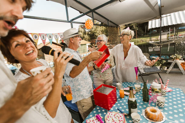 istock Senior people celebrating birthday singing karaoke. 1288627082