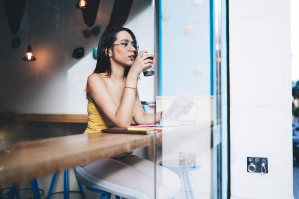 istock Thoughtful woman drinking coffee in cafe 1288628847