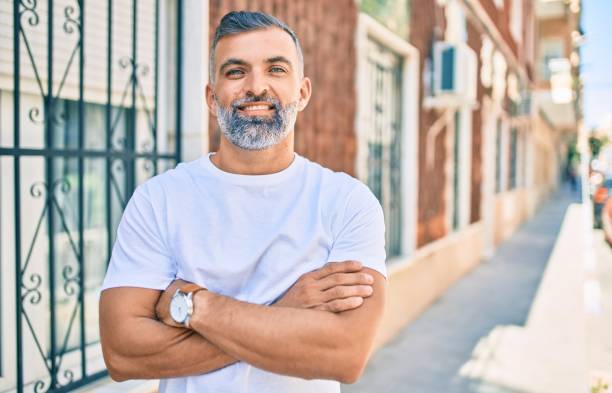 istock Middle age grey-haired man smiling happy standing at the city. 1288631466