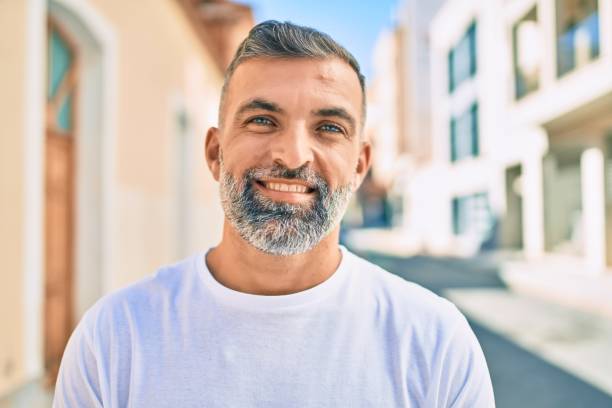 istock Middle age grey-haired man smiling happy standing at the city. 1288631506