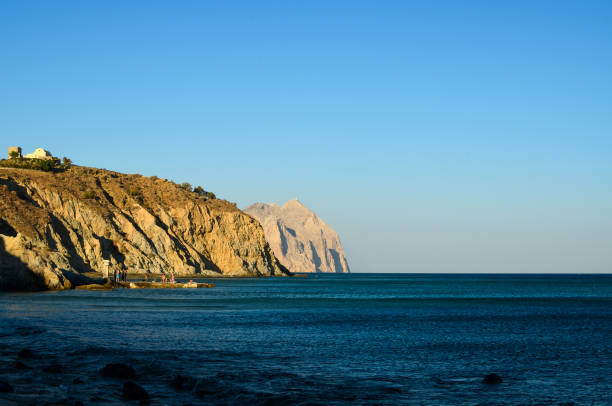 colorful sunset and moon over the coast in Sudak Crimea