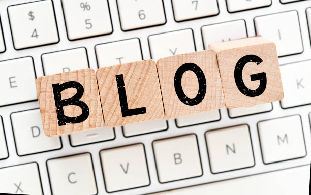 istock The word blog arranged from wooden letters arranged on a white computer keyboard. 1288633052