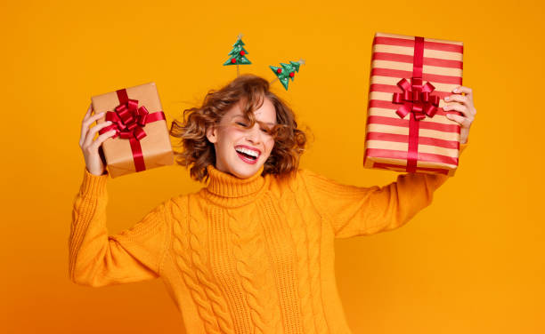 istock Young woman dancing with Christmas presents 1288634880