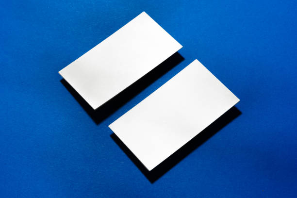 istock Two stacks of blank businesscards on blue background 1288635741